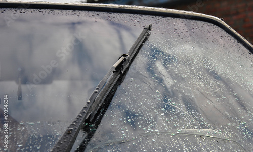 Car wipers wipe raindrops from the car windows