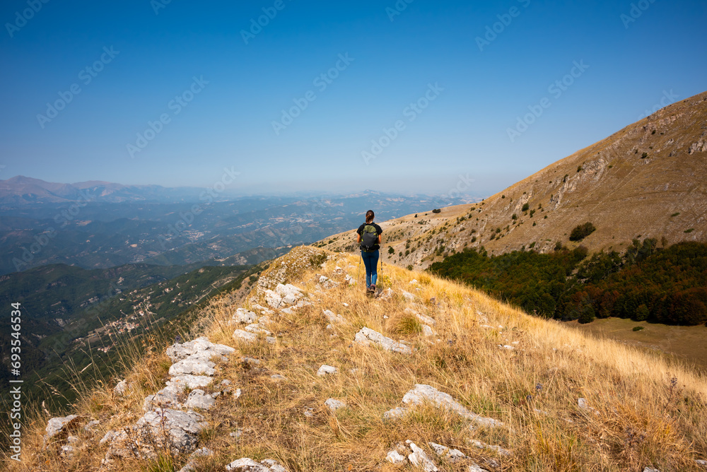 Hiker walking on mountain range in autumn