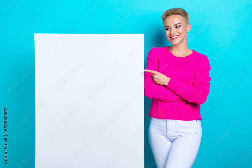 Photo of positive woman with bob hairdo dressed pink sweater look directing at billboard empty space isolated on teal color background Photo of positive woman with bob hairdo dressed pink sweater look directing at billboard empty space isolated on teal color background