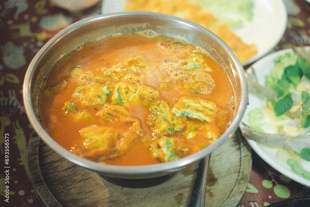 Acacia omelets in vegetable sour soup at restaurant. Traditional Thai style. Close up Acacia omelets in vegetable sour soup at restaurant. Traditional Thai style. Close up