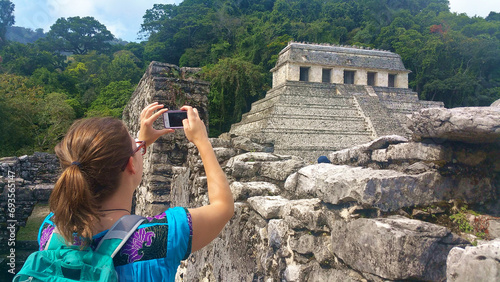 woman takes a cell phone photo at the mayan ruin site of palenque (chiapas, mexico travel, tourism) mobile phone picture, photograh (tourist, traveler, young 20's female) photo