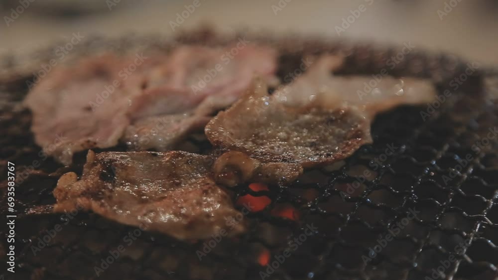 Party for barbecue japanese style, yakiniku. Meats are being cooked on stove in a japanese Party for barbecue japanese style, yakiniku. Meats are being cooked on stove in a japanese