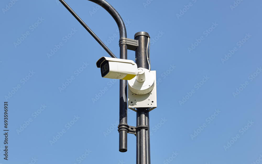 Cctv camera security on pole. Modern surveillance CCTV camera on lamppost on a city street Cctv camera security on pole. Modern surveillance CCTV camera on lamppost on a city street