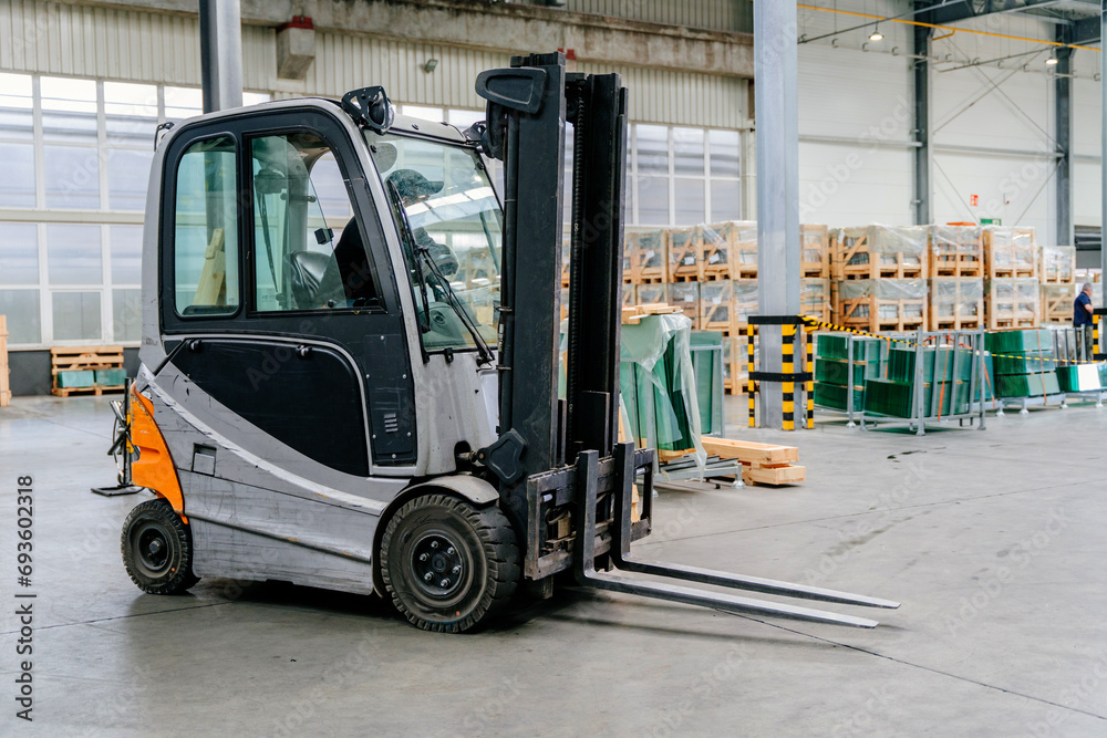 Forklift truck loader in factory. Glass factory, Production plant