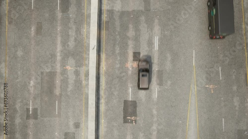 Cars and cloud shadows fly along a multi-lane concrete road with patched potholes. The camera is looking perpendicularly downward.