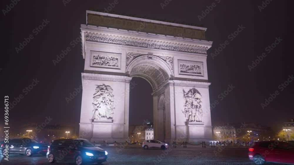 Triumphal arch in the evening on the Champs-Elysees in Paris. Time lapse of centre of Paris. Car traffic on a roundabout. Night city lights Triumphal arch in the evening on the Champs-Elysees in Paris. Time lapse of centre of Paris. Car traffic on a roundabout. Night city lights