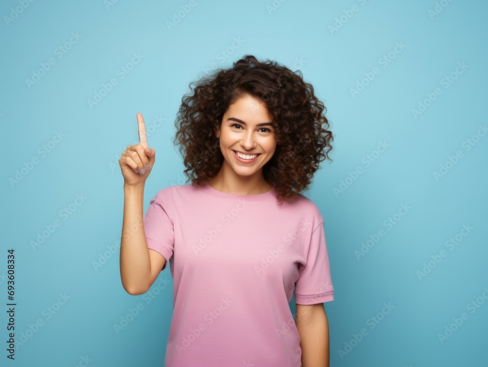 Pointing. Close-up photo of a happy woman, Young woman pointing her finger Pointing. Close-up photo of a happy woman, Young woman pointing her finger