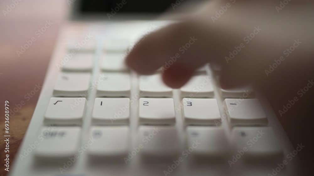 close up of a hand using calculator close up of a hand using calculator