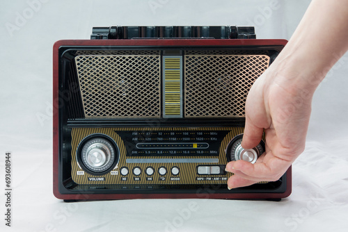 Tableau sur toile A Female Fingers Tuning the Frequency on an Old Vintage Analog Receiver