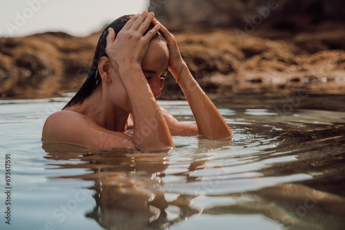 Portrait of wet woman with wet body in ocean water. Woman swim in ocean water photo