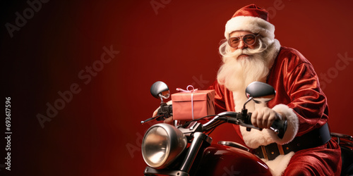 Retro portrait of Santa Claus sitting on a retro motorcycle with a Christmas gift on a red background with copy space.