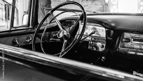the dashboard of a beautiful 1950s cadillac on display at a car show © Fernikon