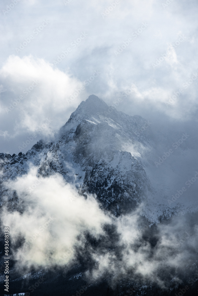 Obraz premium Lonelny Mountain in the clouds Covered in snow Winter Landscape Nature Polana Rusinowa Tatra Mountains