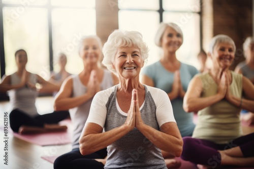 Elderly and middle-aged women doing physical exercises, yoga, pilates in the gym. Active healthy lifestyle