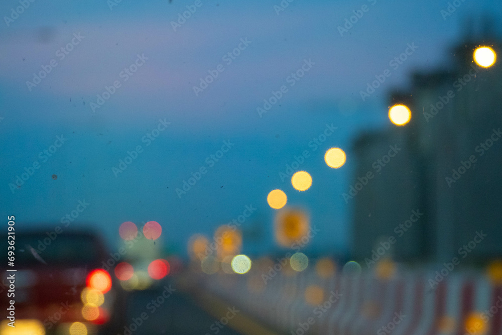 Bokeh, bright shining lights of the district in the nighttime rush hour on blurred background.