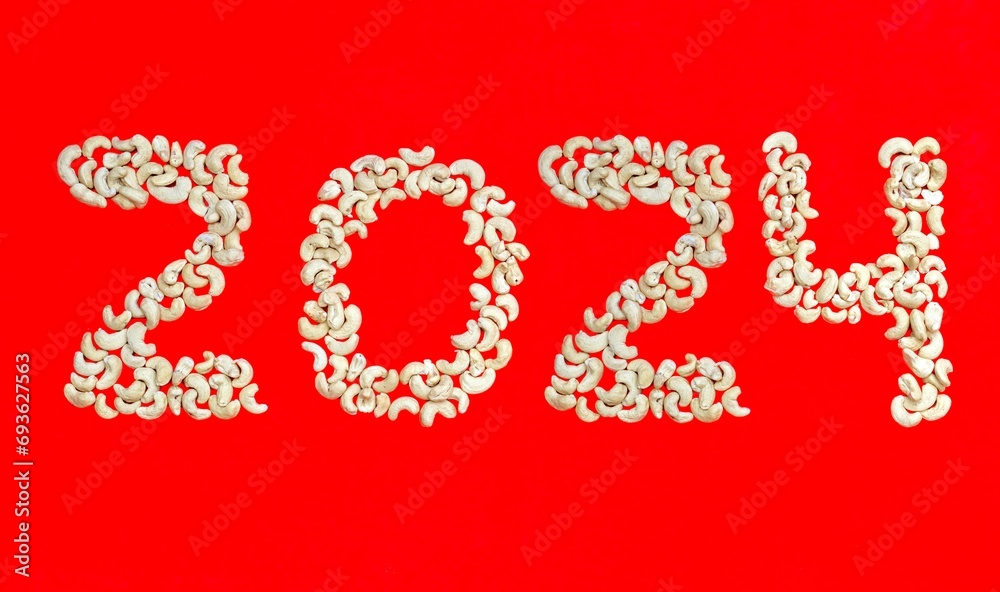 2024 Written with Cashew Nut on Red Background, Happy New Year 2024 Wishing Conceptual Photo