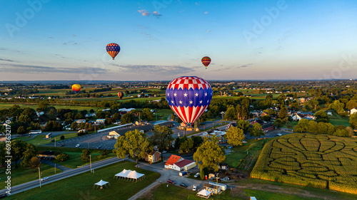 Photo An Aerial View of Multiple Hot Air Balloons Floating Away in Rural Pennsylvania