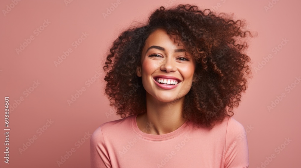 Young smiling charming positive woman, happy joyful cheerful cute curly beautiful girl laughing having fun, looking at camera, standing isolated at pink background, close up headshot portrait. Young smiling charming positive woman, happy joyful cheerful cute curly beautiful girl laughing having fun, looking at camera, standing isolated at pink background, close up headshot portrait.