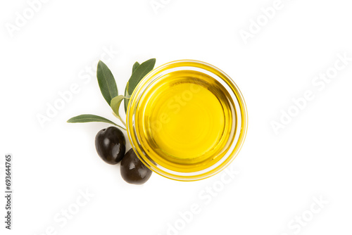 Bowl of fresh olive oil and olives with leaves isolated on white background. Delicious olive oil in a glass bowl. olive oil bottle.