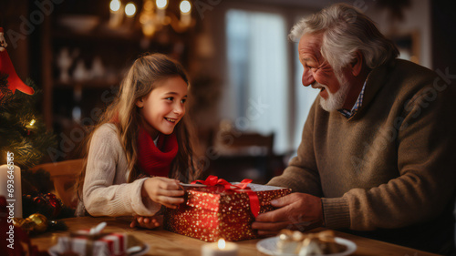 family celebrating Christmas. Grandfather Presenting a Festive Gift to a child. People enjoying Christmas dinner together in a cozy home