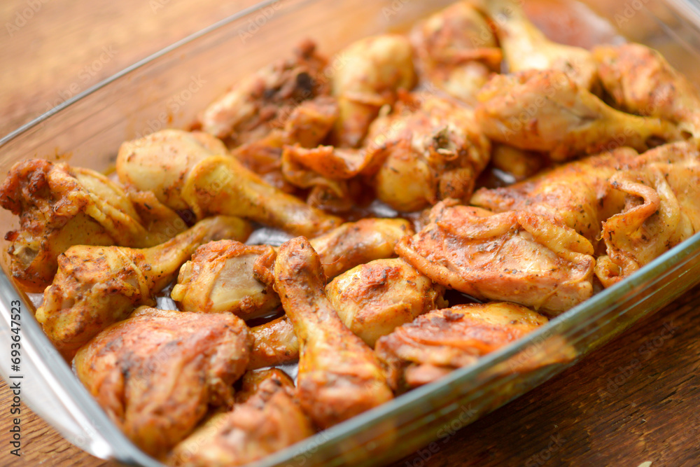 Prepared chicken legs and thighs seasoned and oven-roasted Prepared chicken legs and thighs seasoned and oven-roasted