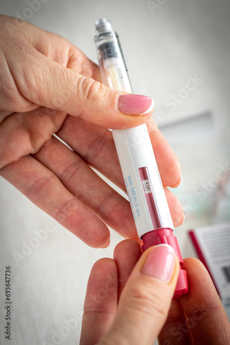 Close upshot of the woman preparing medicine for injection. Healthcare