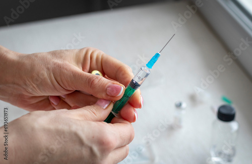 Close upshot of the woman preparing medicine for injection. Healthcare