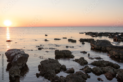 Rocks on sea in sunset