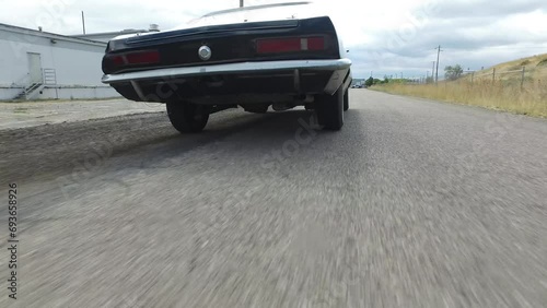 Cinematic shot following stunt vehicle down road