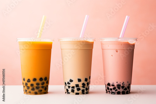 three varieties of boba tea showcased against a backdrop of pink