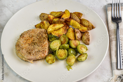 boneless pork chop with rosted brussel sprouts photo