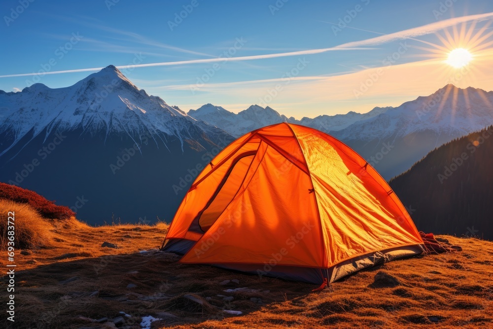 a tent is pitched in the mountains and the sun is shining