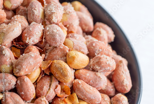 Salted peanuts in a glass bowl