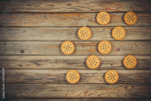 Round vanilla cookies on wooden background