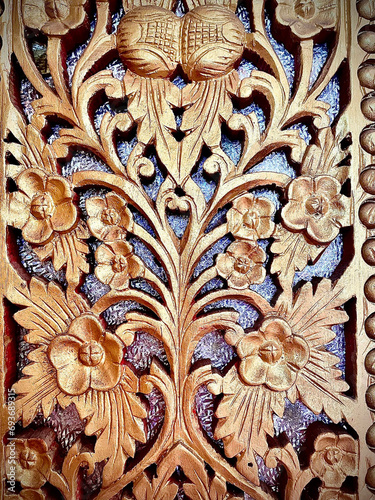 Thai style wood pattern sculpture on the wall of temple in northern Thailand