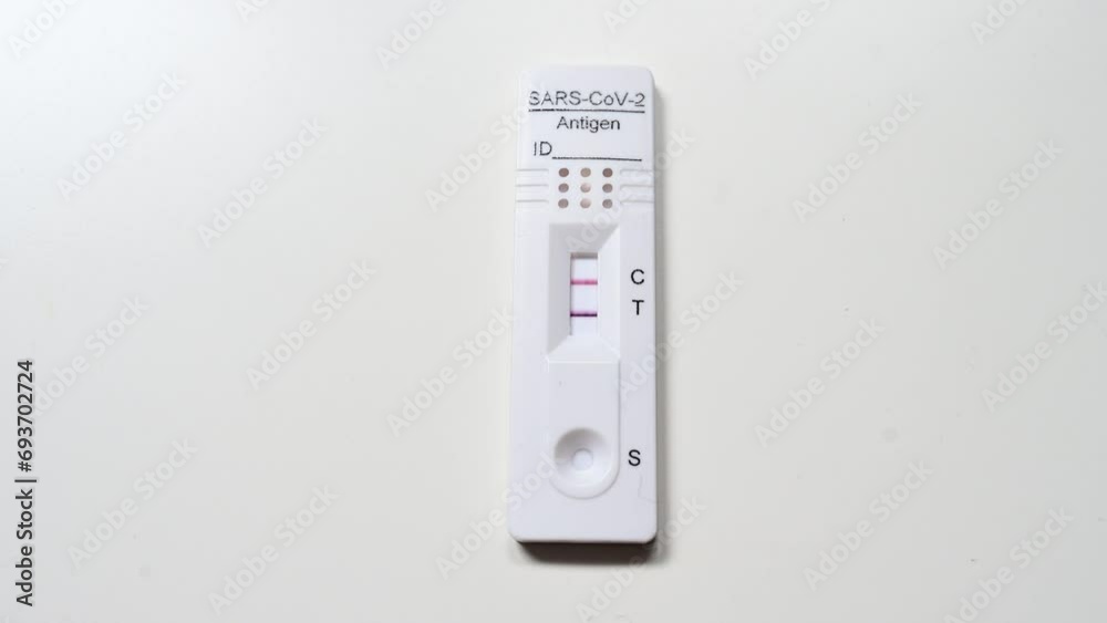 Positive Covid test result using antigen test. Covid-19 test kit. Rapid diagnostic test detecting Coronavirus. Self testing at home. Positive Covid test result using antigen test. Covid-19 test kit. Rapid diagnostic test detecting Coronavirus. Self testing at home.