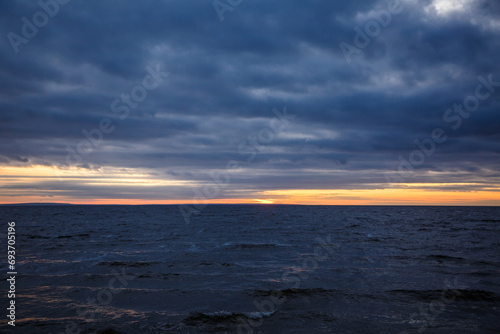 Cloudy sunset on the seashore, beautiful sunset by the sea © Anton