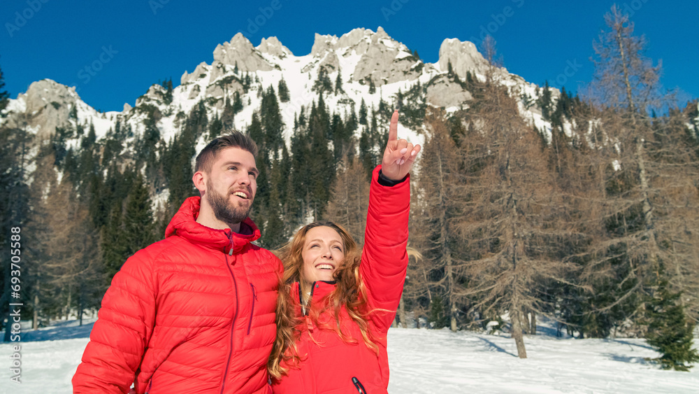 Happy couple enjoys a relaxing day outdoors in a stunning snowy landscape