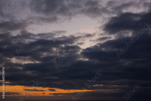 Beautiful orange sunset with big rain clouds