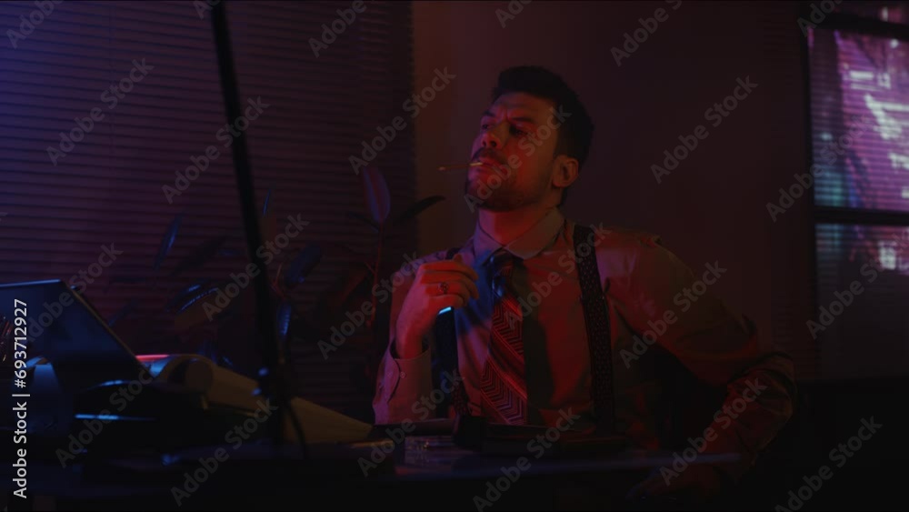 Medium side shot of Caucasian bearded man in old-fashioned vintage clothes smoking cigarette in neon lit office at night Medium side shot of Caucasian bearded man in old-fashioned vintage clothes smoking cigarette in neon lit office at night