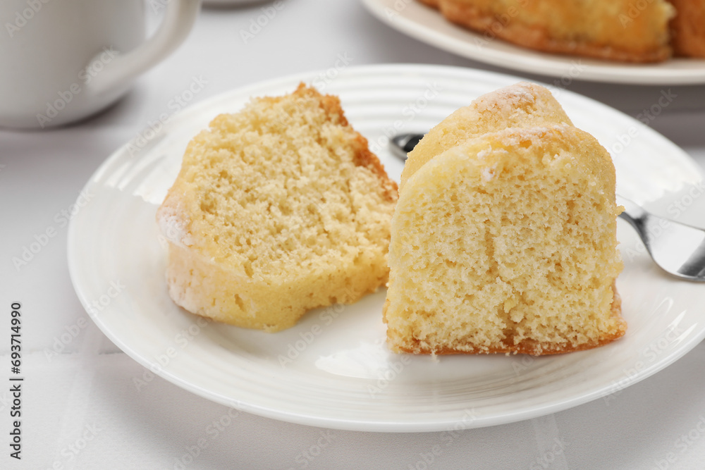 Pieces of delicious sponge cake on white table, closeup Pieces of delicious sponge cake on white table, closeup