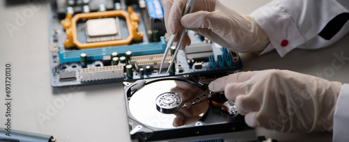 person in gloves work in laboratory, repair broken hdd hard drive