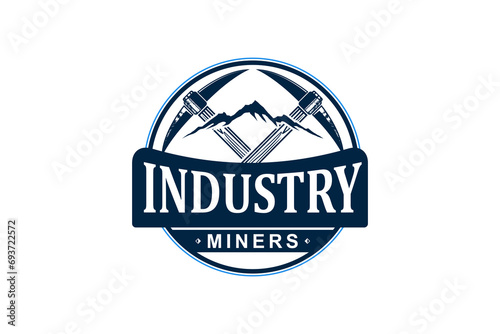 Manual mining logo design using a pick ax in rocky mountain, rounded badge style.