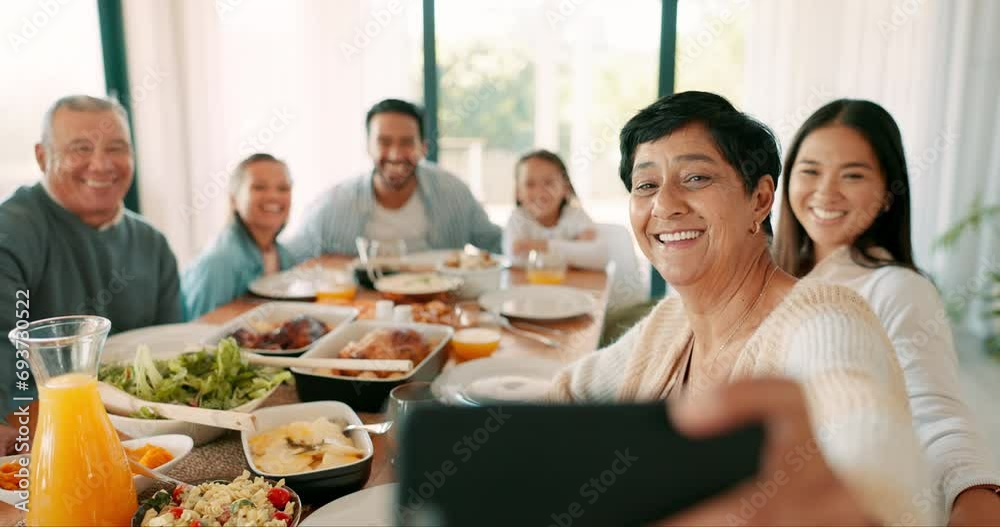 Thanksgiving selfie with a senior woman and her family together eating food for bonding in celebration. Love, lunch or brunch with a grandmother taking a picture in the dining room of her home Thanksgiving selfie with a senior woman and her family together eating food for bonding in celebration. Love, lunch or brunch with a grandmother taking a picture in the dining room of her home
