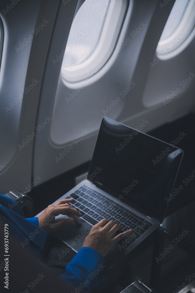 Using mobile and laptop, Thoughtful asian people female person onboard, airplane window, perfectly capture the anticipation and excitement of holiday travel. chinese, japanese people. Using mobile and laptop, Thoughtful asian people female person onboard, airplane window, perfectly capture the anticipation and excitement of holiday travel. chinese, japanese people.