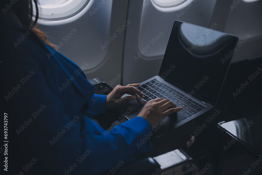 Using mobile and laptop, Thoughtful asian people female person onboard, airplane window, perfectly capture the anticipation and excitement of holiday travel. chinese, japanese people. Using mobile and laptop, Thoughtful asian people female person onboard, airplane window, perfectly capture the anticipation and excitement of holiday travel. chinese, japanese people.