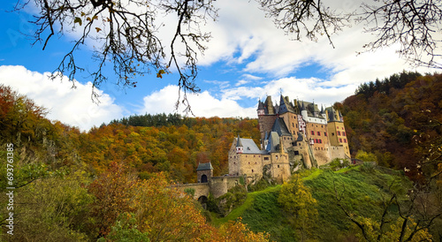 Autumn trees scene with Eltz Castle or Burg Eltz. Medieval castle on the hills above the Moselle River. Rhineland-Palatinate Germany. photo
