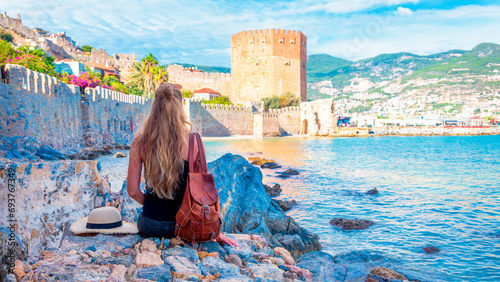 Woman travelling in Turkey, Alanya city and red tower