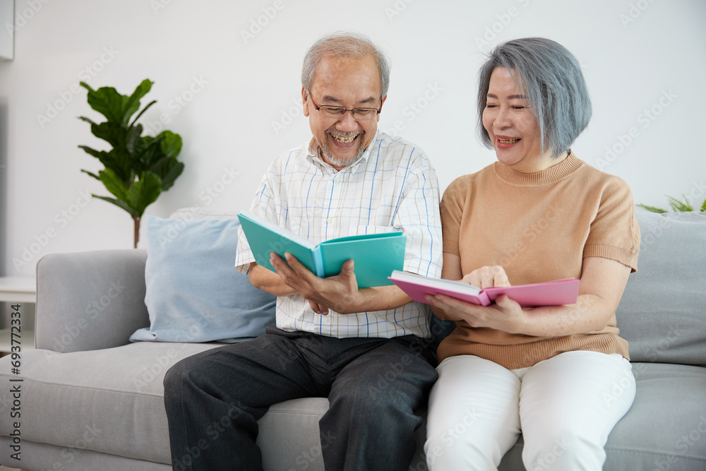 senior couple reading a books and feeling enjoy on sofa senior couple reading a books and feeling enjoy on sofa