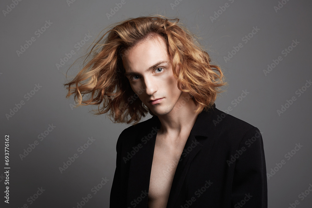 Boy with long hair. handsome young Man with trendy Hairstyle